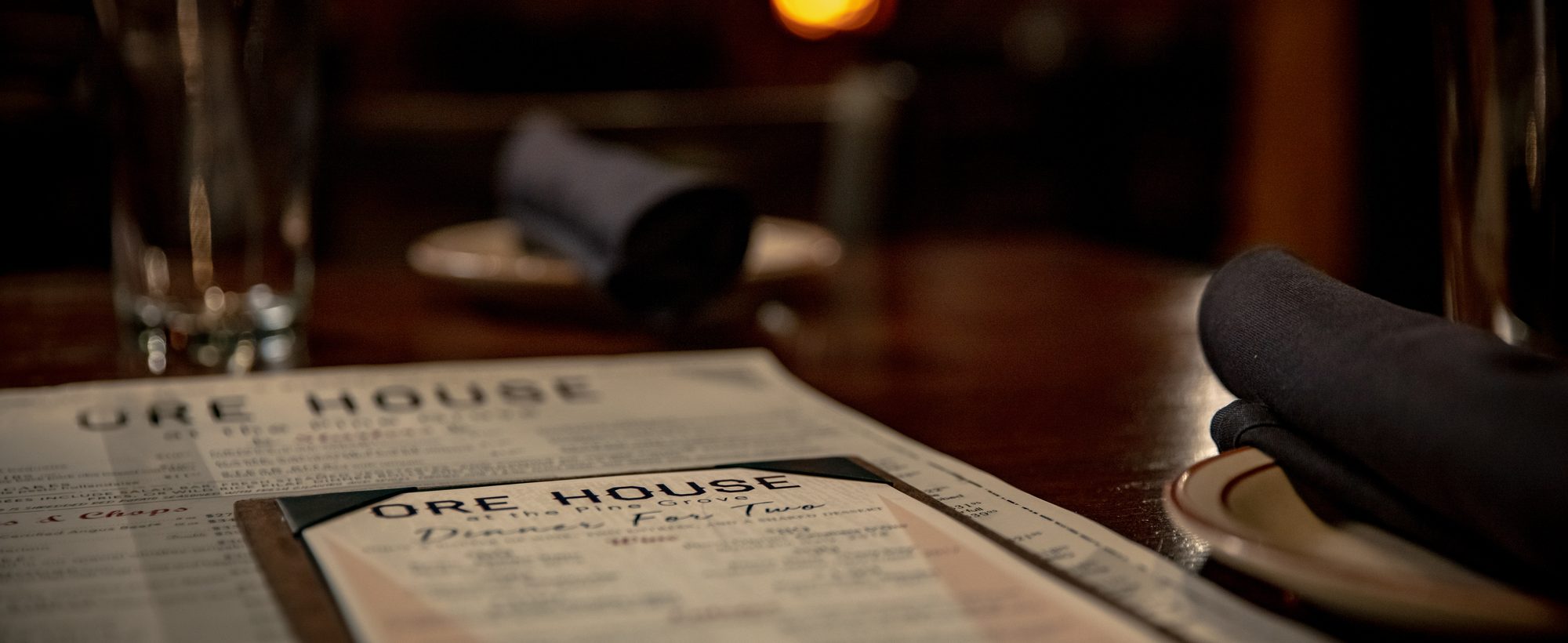 A candlelit table set for dinner at the Ore House